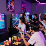 Engaged gamers playing PAKDE4D in a lively modern arcade atmosphere.